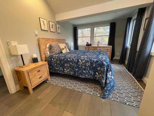 a bedroom with a bed and a dresser and a window at SKI Bike, Hike & Golf Townhouse w/ Hot tub in Ellicottville