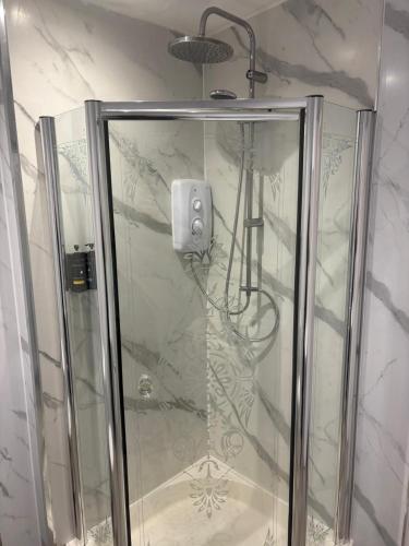 a shower with a glass door in a bathroom at The Ferry Boat Inn in Ullapool