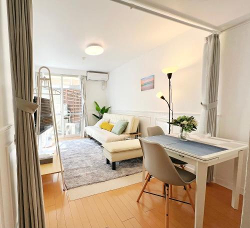 a living room with a table and a couch at Ikebukuro 1 stop 2 min Designer Entire House 3BR up to 8 guests 3 min to Convenience Store in Tokyo