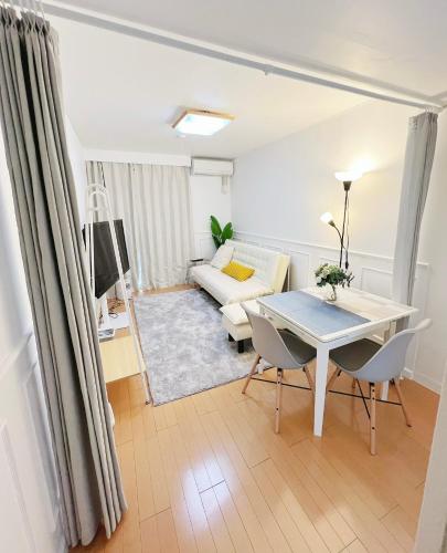 a living room with a table and a couch at Ikebukuro 1 stop 2 min Designer Entire House 3BR up to 8 guests 3 min to Convenience Store in Tokyo