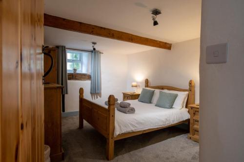 a bedroom with a bed and a window at Bryn Lon Bach in Caeʼr-geiliog