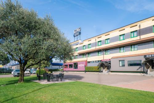 a building with a tree in front of it at Smart Hotel King, by R Collection Hotels in Varedo
