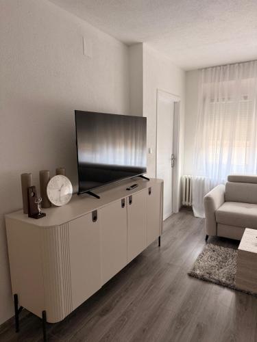 a living room with a flat screen tv and a couch at Apartman Central Lux in Banja Luka