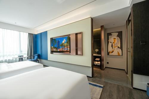 a bedroom with a white bed and a blue wall at Maihao Hotel in Rujiazhuang