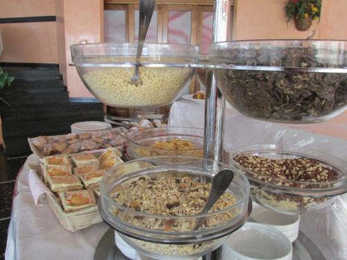 a table topped with bowls of food and other foods at Hotel London in Cattolica
