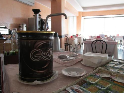 a coca cola blender on a table in a restaurant at Hotel London in Cattolica