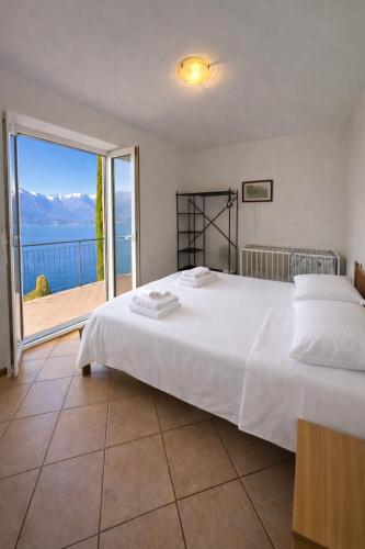 a bedroom with a bed with a view of the ocean at Villa crotto Lake View in Perledo