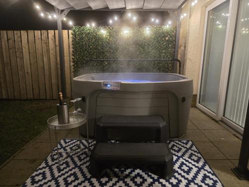 a bath tub sitting on a patio with a table at North Coast Nook in Portrush