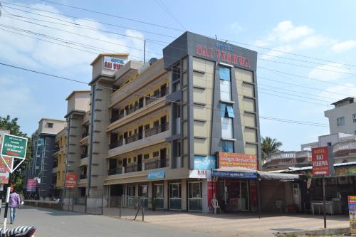 a building with a sign for a hotel at Hotel Sai Vishwa in Shirdi