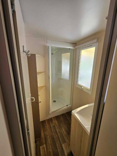 a small bathroom with a shower and a sink at camping de l'or bleu in Barrême