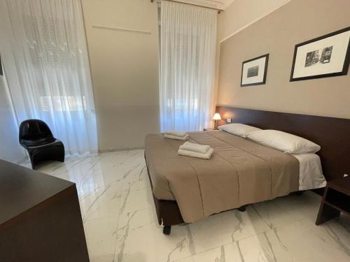 a bedroom with a bed with two towels on it at Club Hotel in Milan