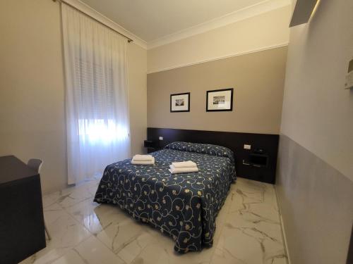 a bedroom with a bed with two towels on it at Club Hotel in Milan