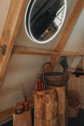 a bathroom with a sink and a mirror on the ceiling at Het Punthuisje in Lanaken