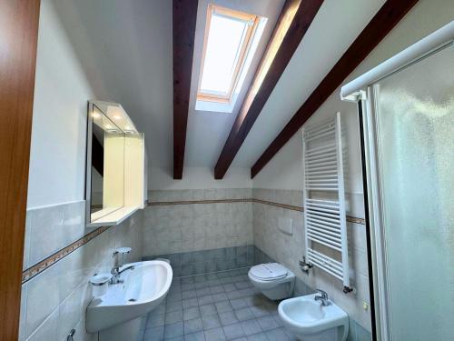 a bathroom with two sinks and two toilets at Stella Marina in Grado