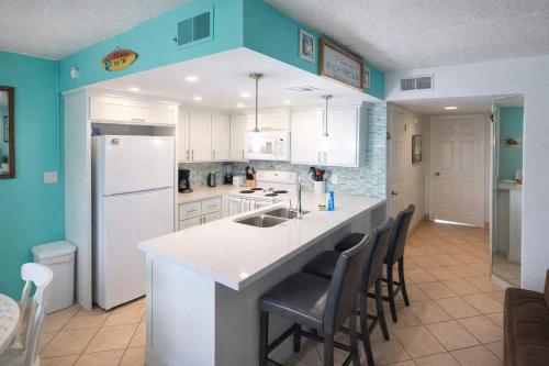 a kitchen with a white refrigerator and a counter at Max Walkable Location 1st Floor 2 Patios in South Padre Island