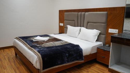a bedroom with a large bed with white pillows at PD Residency in Duttnager