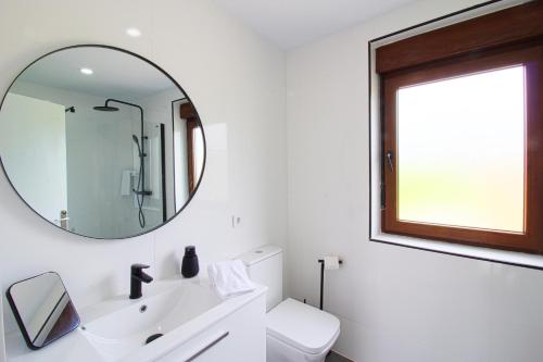 a bathroom with a sink and a mirror at La balcon de Sanfer in Santillana del Mar