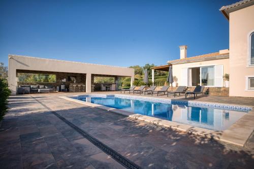 a swimming pool in the backyard of a house at Casa Rosa - Heated Pool & Sea Views in Loulé