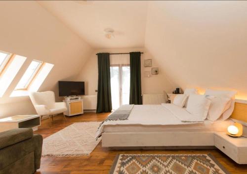 a bedroom with a large bed and a living room at Pensiunea Bucuria Cheia & Ferma Animale in Cheia