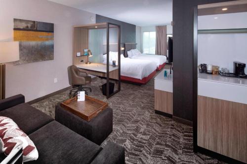 a hotel room with a couch and a bed at Springhill Suites By Marriott Newark Downtown in Newark