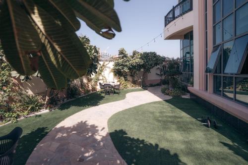 a walkway leading to a yard with a table and chairs at Full Moon Guesthouse in Dubai