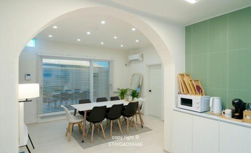 a kitchen and dining room with a table and chairs at Stay Gaonhae in Gyeongju