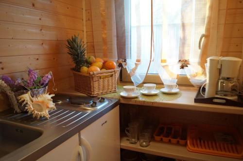 a kitchen with a counter with a basket of fruit at Villa Amber in Sarbinowo