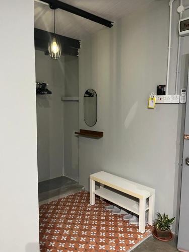 a room with a bench and a mirror on the wall at Roomah En-suite attached-bath R6 in Ipoh