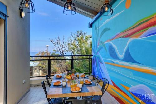 a dining room with a table and a mural at TIGOUYA - House of 135m - 2 bedrooms Jacuzzi in Stella Matutina