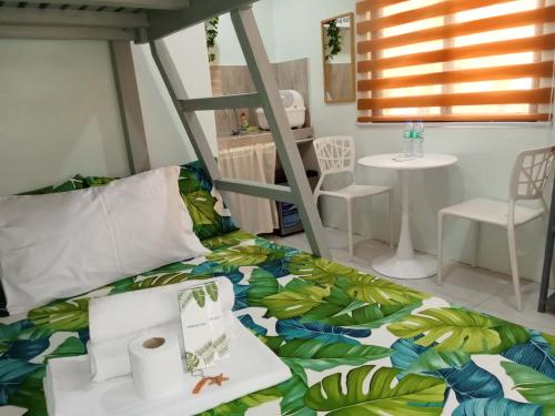 a room with a bed and a table and chairs at JAG Homes in Puerto Princesa City