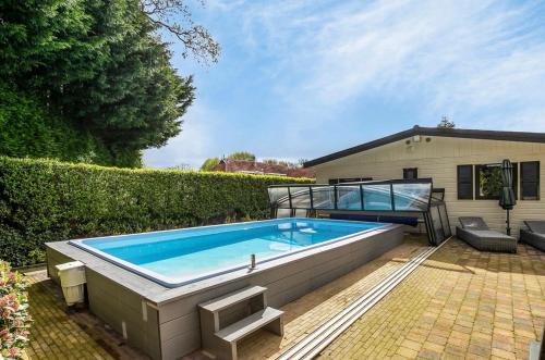 a large swimming pool in front of a house at De Bosparel in Doldersum
