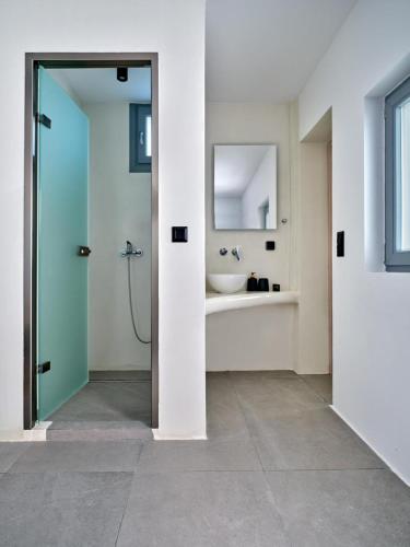a bathroom with a shower and a sink at Cozy Hideaway Room with Private Jacuzzi in Krotiri