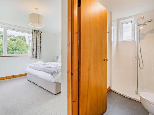 a bedroom with a bed and a bathroom with a shower at 5 Bed in Dunkeld oc-90585 in Dunkeld
