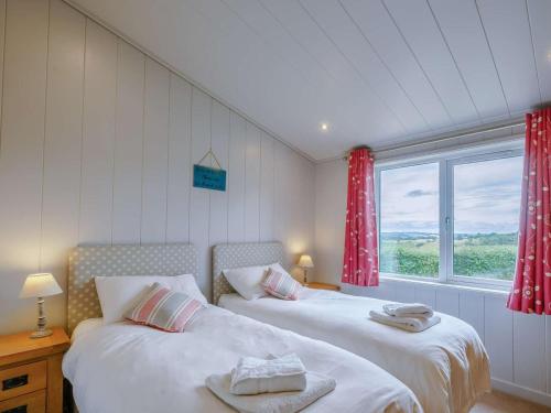 two beds in a room with a window at 3 Bed in St. Andrews oc-88545 in Balmullo