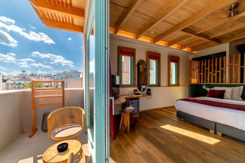 a bedroom with a bed and a balcony at Artion City Boutique Hotel in Heraklio