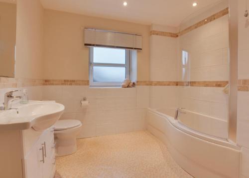 a bathroom with a sink and a tub and a toilet at 3 Bed in Catterick oc-ds934 in Catterick Bridge