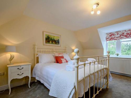 a bedroom with a white bed and a window at 2 Bed in Langholm oc-83344 in Langholm