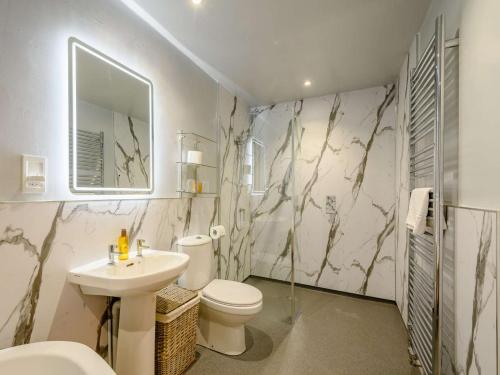 a bathroom with a sink and a toilet and a mirror at 2 Bed in Sanquhar oc-89403 in Sanquhar