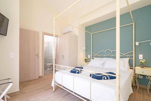 a bedroom with a four poster bed with a large window at Villa Michou Helios by Villa Plus in Lourdata