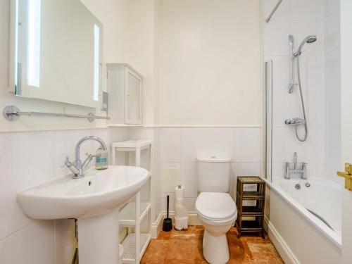 a bathroom with a sink and a toilet and a tub at 3 Bed in Edinburgh oc-79008 in Edinburgh