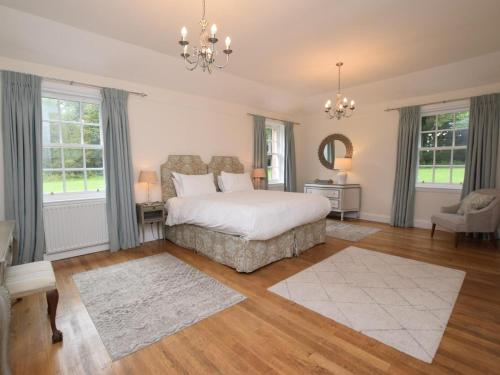 a bedroom with a bed and a chandelier at 3 Bed in Annan oc-75355 in Annan