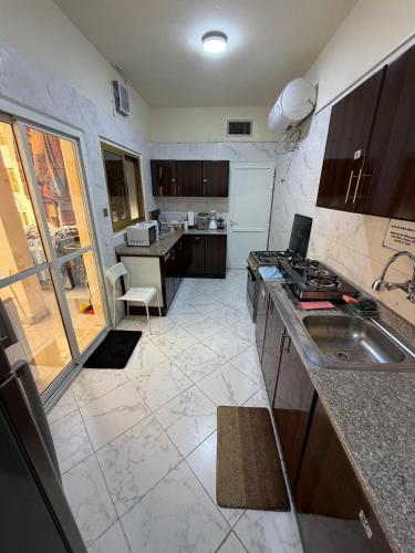 a kitchen with a sink and a counter top at MAMA DELiGHT HOME in Abu Dhabi