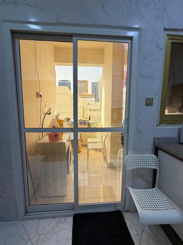 a room with a sliding glass door to a balcony at MAMA DELiGHT HOME in Abu Dhabi