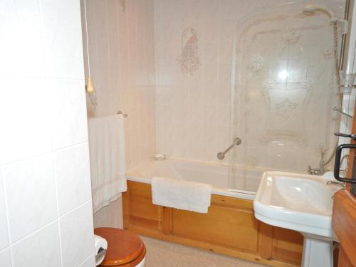 a bathroom with a tub and a sink at 1 Bed in Nethy Bridge oc-28823 in Nethy Bridge
