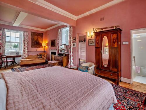 a bedroom with a large bed and a bathroom at 4 Bed in Penrith oc-94247 in Greystoke