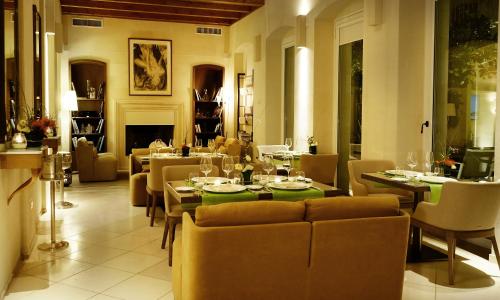 a dining room with tables and chairs and a fireplace at La Fiermontina Luxury Home Hotel in Lecce