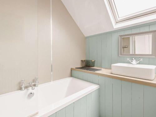a bathroom with a white sink and a mirror at 3 Bed in Kirriemuir oc-75284 in Kirriemuir
