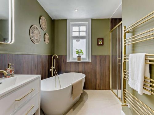 a bathroom with a tub and a sink at 3 Bed in Gullane oc-96141 in Gullane