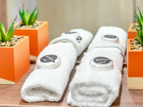 a row of towels on a table with potted plants at 2 Bed in St. Andrews oc-95035 in St. Andrews