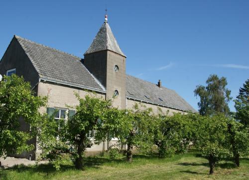an old building with trees in front of it at Bed & Brood De Vogelpoel in Wijk bij Duurstede